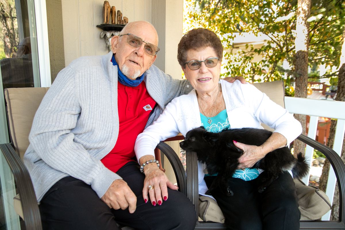 Larry and Darlene Sannes pause for a photo with Tiny Bear, their pet Pomeranian, at their home in the Sans Souci West retirement community in Spokane. The couple celebrated their 65th anniversary on Sept. 16.  (Libby Kamrowski/The Spokesman-Review)