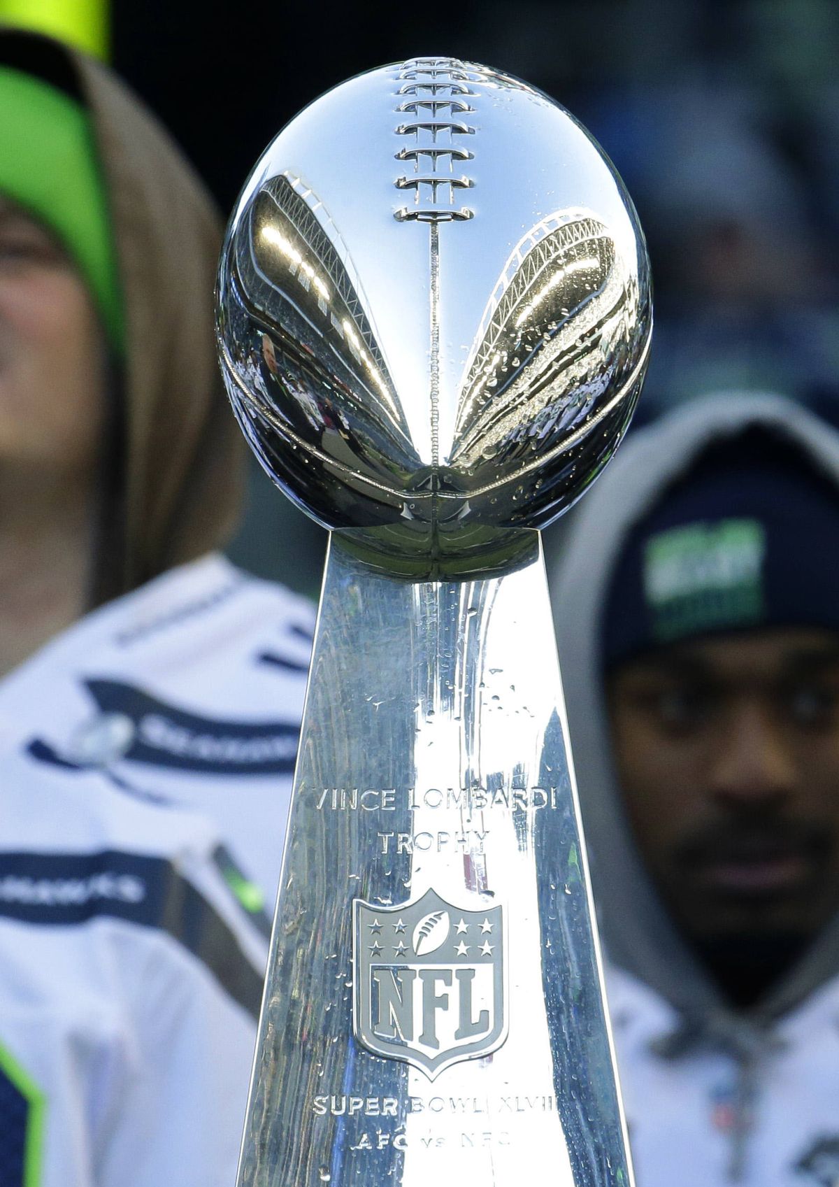 CenturyLink Field is reflected in the Vince Lombardi Trophy during a February rally for the Super Bowl champion Seahawks. (Associated Press)