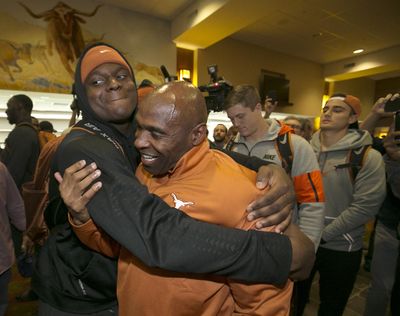 Texas linebacker Erik Fowler, left, gives coach Charlie Strong a hug after several players came to support and watch their coach address his coaching status during his weekly NCAA college football media availability Monday, Nov. 21, 2016, in Austin, Texas. (Ralph Barrera / Associated Press)