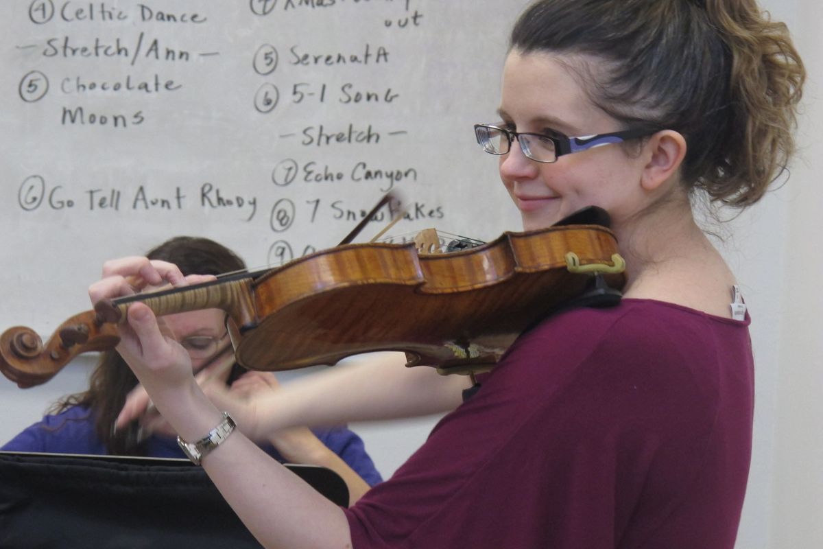 In this Nov. 17, 2012, photo, conductor Gabrielle Whitfield practices the violin with the Hiland Mountain Correctional Facility Orchestra in Eagle River, Alaska. After serving a 14-year sentence for murder, Sarah Jane Coffman, a founding member of the women's string orchestra at the prison in 2003, will debut as a citizen member when the two annual holiday concerts are held Dec. 8, 2012. (Mark Thiessen / Associated Press)