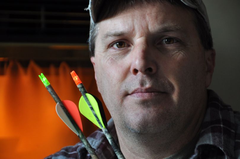 Jim Sutton of Spokane displays arrows with lighted nocks, which he believes should be allowed for hunting in Washington. (Rich Landers)