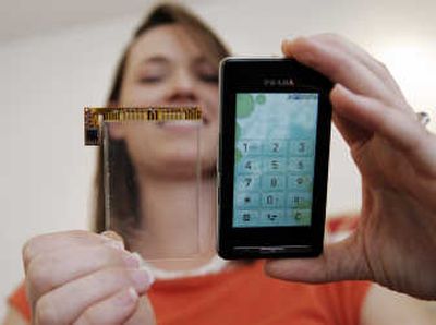 
Synaptics employee Robyn McElhiney holds up their clear pad technology next to LG Electronics Co.'s LG Prada cell phone at Synaptics headquarters in Santa Clara, Calif. Associated Press
 (Associated Press / The Spokesman-Review)