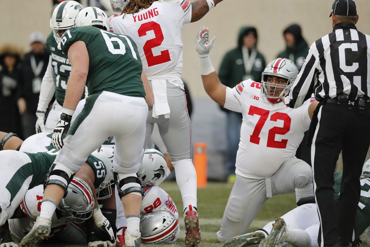 In this 2018 photo, Ohio State defensive tackle Tommy Togiai (72) reacts after teammate defensive tackle Dre