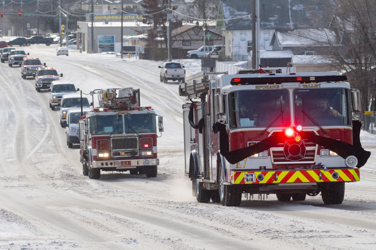 A funeral procession for Spokane Valley Fire Captain Timothy Cruger, who died Dec. 24, 2018, due to complications from toxic fumes he inhaled while fighting fires, makes its way up Evergreen Road on its way to Spokane Valley Assembly Church on Saturday, Feb. 9, 2019, in Spokane Valley, Wash. (Tyler Tjomsland / The Spokesman-Review)