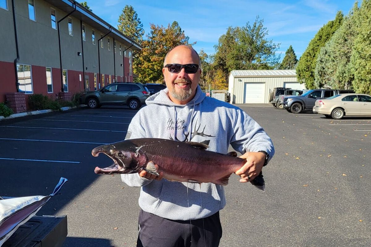 Matt Hosking holds up the Idaho state record coho salmon.  (Courtesy of Idaho Fish and Game)