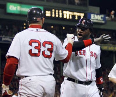 
Jason Varitek, left, greets David Ortiz after Ortiz scored on Mike Lowell's two-run double. Associated Press
 (Associated Press / The Spokesman-Review)