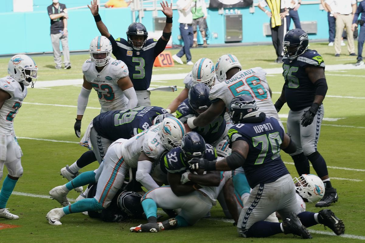 Seattle Seahawks running back Chris Carson (32) scores a touchdown during the second half of an NFL football game against the Miami Dolphins, Sunday, Oct. 4, 2020, in Miami Gardens, Fla. The Seahawks defeated the Dolphins 31-23.  (Lynne Sladky)