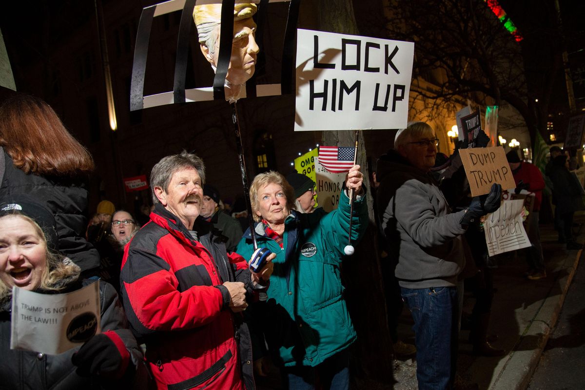 Hundreds of protesters showed their support for Impeaching President Donald Trump during an impeachment rally Tuesday night in the courtyard of the Thomas S. Foley Federal Courthouse. (Colin Mulvany / The Spokesman-Review)
