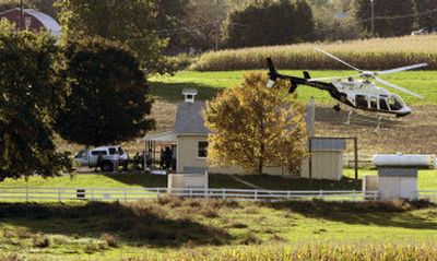 
A police helicopter circles the one-room Pennsylvania schoolhouse where four people died Monday. 
 (Associated Press / The Spokesman-Review)
