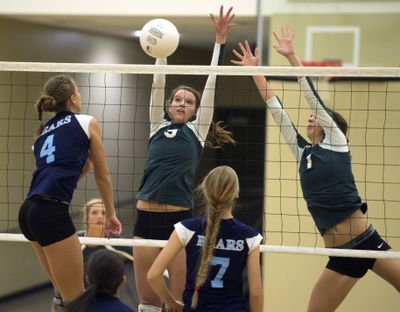 Central Valley’s Keann White (4) hits against Shadle Park’s Maggie Jarvis and Holly Hamblen, right. (Jesse Tinsley)