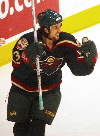 
Sergei Zholtok of Latvia celebrates a goal when he played with the Wild in 2003.
 (Associated Press / The Spokesman-Review)