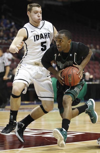 Hawaii guard Shaquille Stokes (4) drive to the basket while being guarded by Idaho center Connor Hill (5) during an NCAA college basketball game in the Western Athletic Conference tournament, Thursday at The Orleans Arena in Las Vegas. Hawaii defeated Idaho 72-70. (Associated Press)