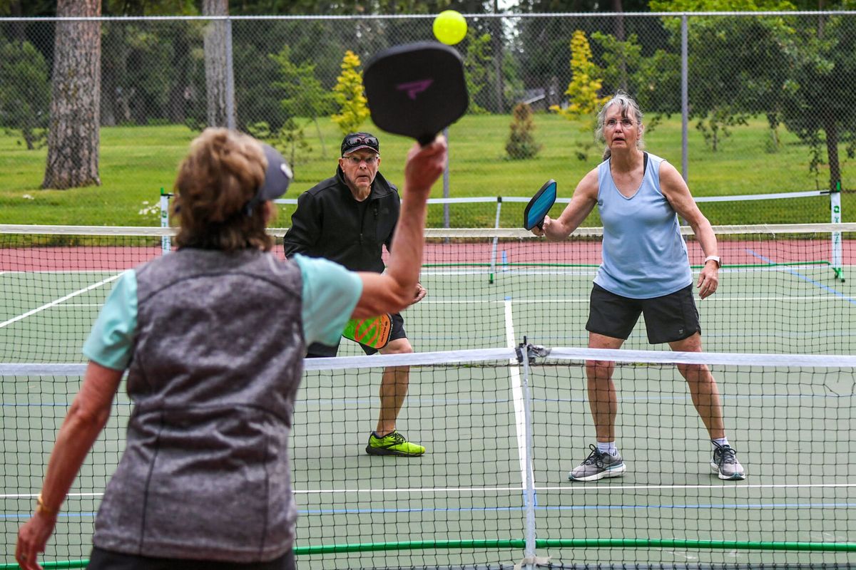 Pickleballers Jeanie Haskell, foreground, returns a volley to Ken Croy and Sharon Croy at the Comstock Park tennis courts on July 15. (Dan Pelle/The Spokesman-Review)