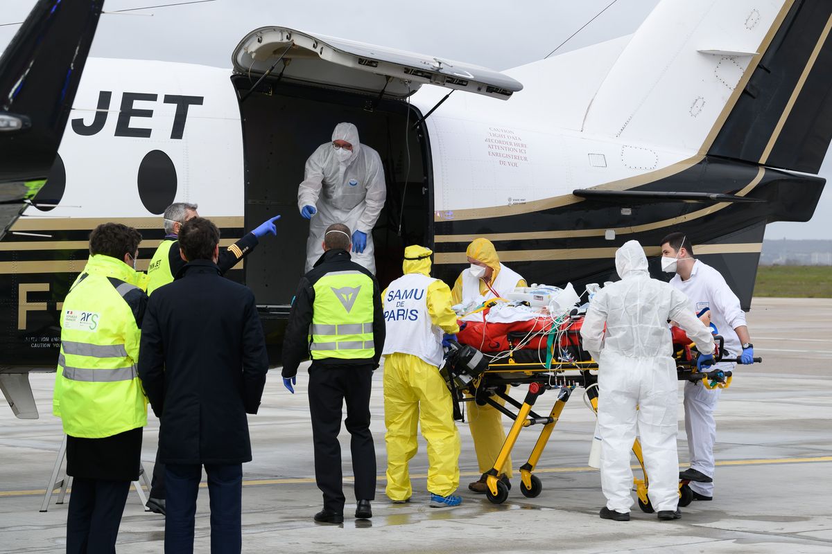 FILE - In this March 14, 2021, file photo, a patient infected with COVID-19 is loaded into a plane heading to a western France hospital, at Orly airport, south of Paris. Health experts say the surge in coronavirus cases in Europe should serve as a warning to the U.S. not to drop its safeguards too early.  (Jacques Witt)
