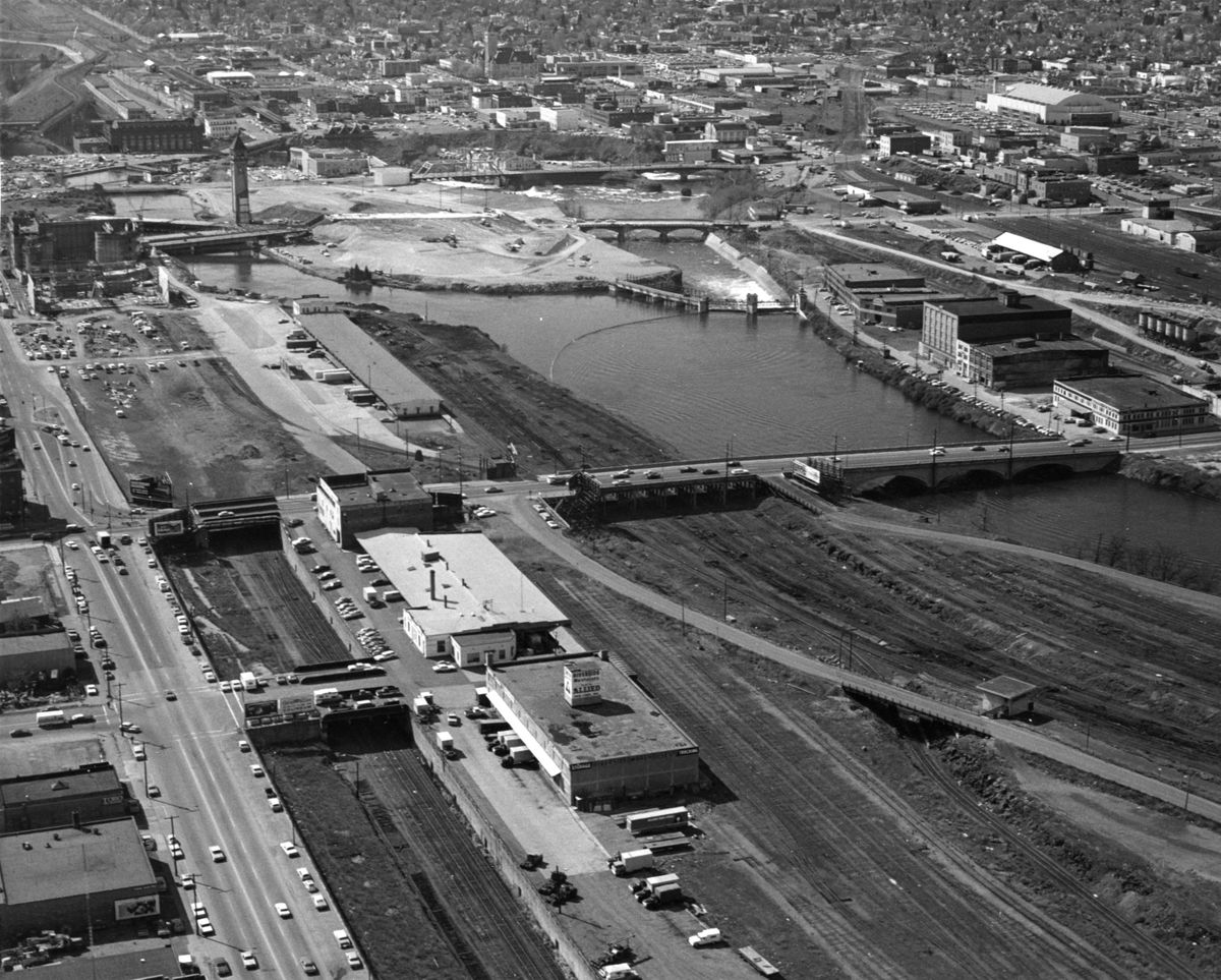 1973: During preparations for Expo ’74, some of Spokane’s old buildings would stay around for a few years after the fair. In the foreground, buildings at Division Street and Spokane Falls Boulevard, left, are the Riverside Warehouses, home of Allied Van Lines an many other businesses and a longtime grocery warehouse that served the MacMarr stores, an early grocery chain. Facing Division is the multistory factory headquarters of F.O. Berg Company, the venerable manufacturer of tents and awnings. By the late 1980s, all the buildings were vacant or demolished and the land awaiting redevelopment.  (SPOKESMAN-REVIEW PHOTO ARCHIVES)