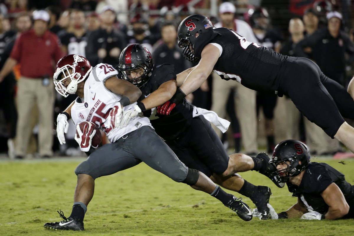 Washington State running back Jamal Morrow is brought down by Stanford defenders during the second half. (Associated Press)