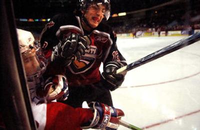 
Spokane Chiefs defenseman Matt  McCue takes a shot from Vancouver Giants right winger Kyle Lamb in the first period Wednesday night at the Arena.  
 (Brian Plonka / The Spokesman-Review)