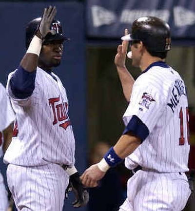 
Doug Mientkiewicz's third-inning homer scored Cristian Guzman, left, in front of him, giving Minnesota a 4-0 lead.Doug Mientkiewicz's third-inning homer scored Cristian Guzman, left, in front of him, giving Minnesota a 4-0 lead.
 (Associated PressAssociated Press / The Spokesman-Review)