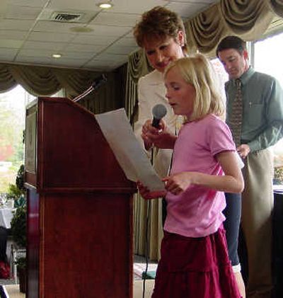 
Amy Cantrell, fourth-place winner, reads her essay as Patti McKerricher Boyd, SAR president, holds the microphone. Also pictured is Glen Carey of Woodard Properties, the 2008 REALTOR® contest chairman.
 (The Spokane Association of REALTORS®. / The Spokesman-Review)