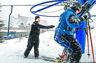 
Ski lift operator Tyrel Manley, left, sends two skiers up Chair One at Schweitzer Mountain Resort on Thursday.  Resort management has announced two lifts will be built to replace the old one that takes skiers to the south bowl of Schweitzer Basin. 
 (Jesse Tinsley / The Spokesman-Review)