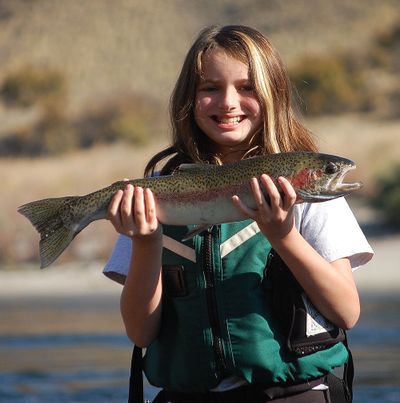 Sophia Boson, 11, shows off the steelhead she caught while fishing on the Snake River during the Idaho Department of Fish and Game Kids Steelhead Fishing Clinic in October 2013.
 (Eric Barker / Lewiston Tribune)