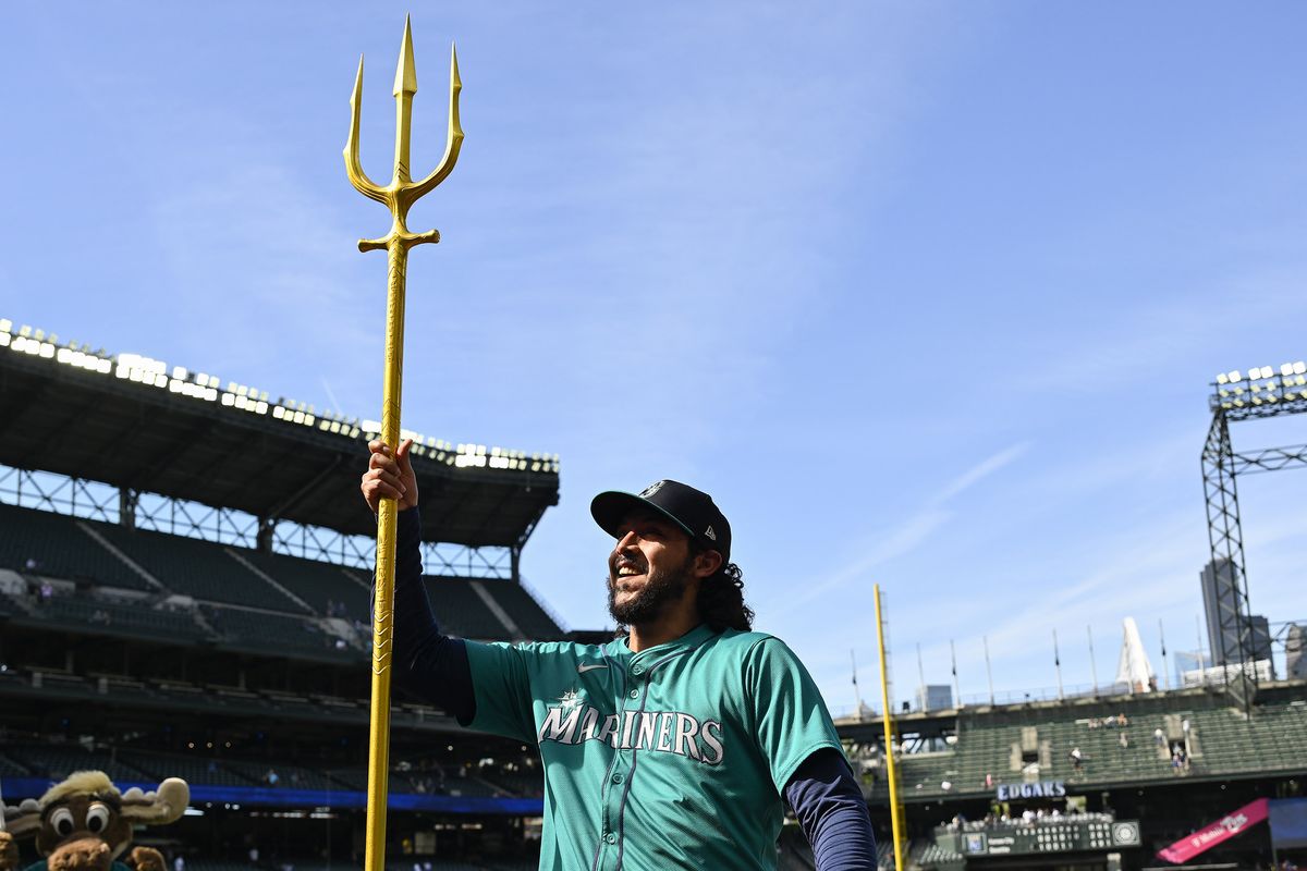 Andres Muñoz holds up the team trident after the Seattle Mariners’ 4-2 win over the Kansas City Royals at T-Mobile Park on May 15 in Seattle.  (Getty Images)