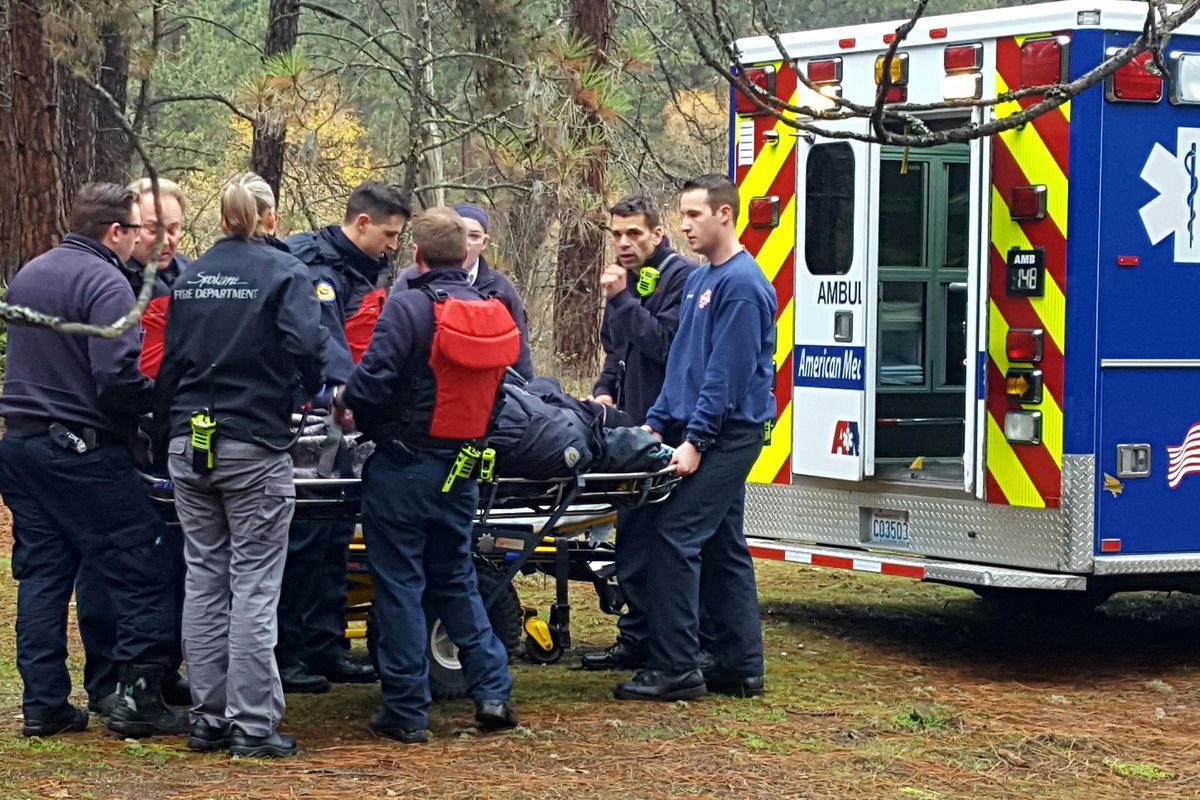 Paramedics load a man into an ambulance after he was rescued from the Spokane River near the T.J. Meenach Bridge on Thursday, Nov. 17, 2016. (Chad Sokol / The Spokesman-Review)