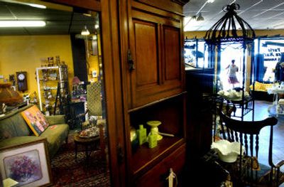 
Items available at Paris Flea Market in Coeur d'Alene are reflected in the mirrored door of an Eastlake cabinet.
 (The Spokesman-Review)