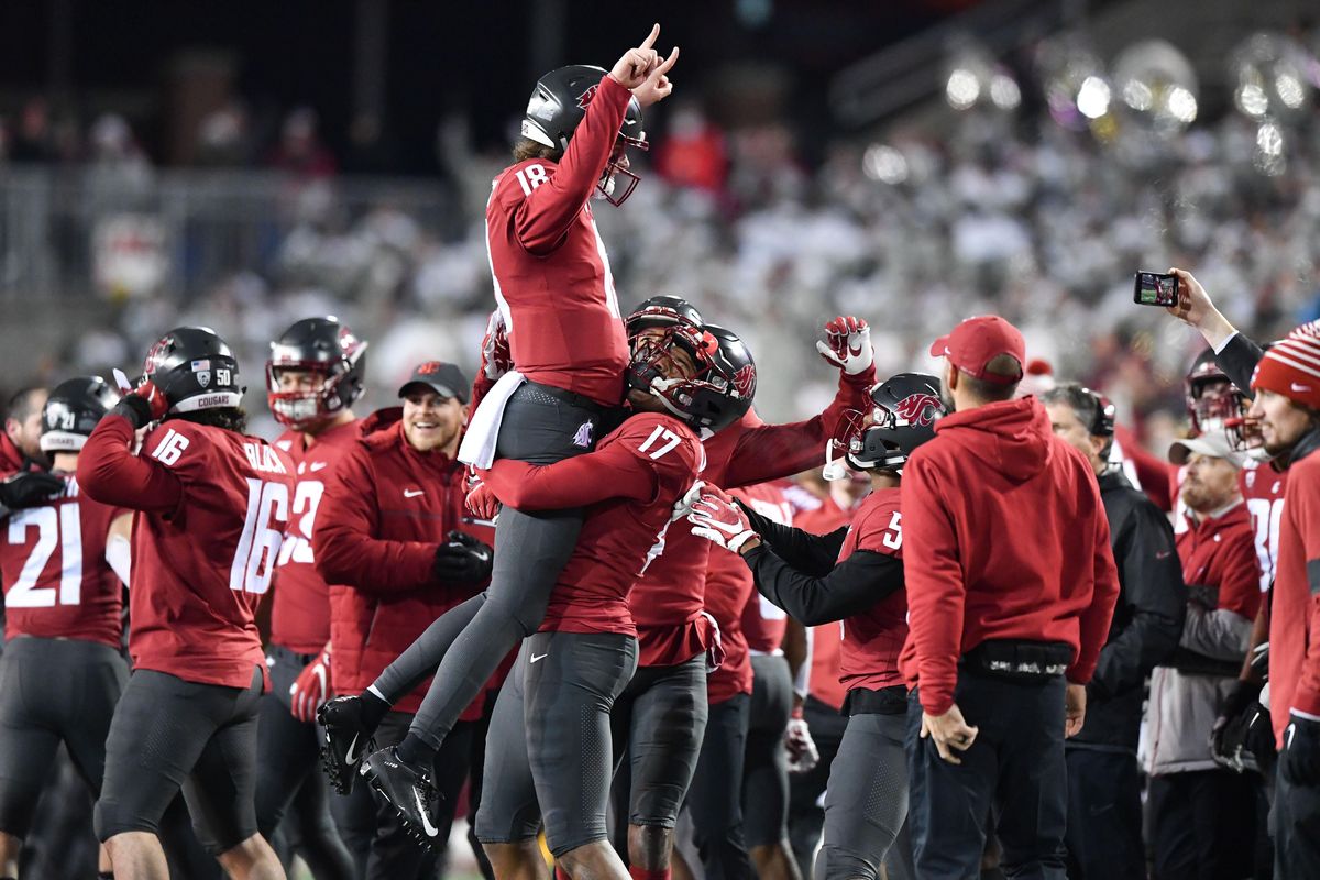 Washington State Cougars quarterback Anthony Gordon (18) is hoisted skyward by Washington State Cougars wide receiver Kassidy Woods (17) after WSU scored the go-ahead touchdown in the final moments of the second half of a college football game on Saturday, November 23, 2019, at Martin Stadium in Pullman, Wash. WSU won the game 54-53. (Tyler Tjomsland / The Spokesman-Review)
