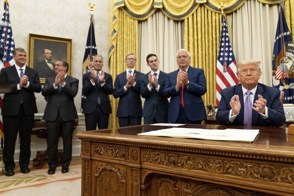 President Donald Trump, accompanied by U.S. Ambassador to Israel David Friedman, second from right, and others applaud in the Oval Office at the White House, Wednesday, Aug. 12, 2020, in Washington. Trump said on Thursday that the United Arab Emirates and Israel have agreed to establish full diplomatic ties as part of a deal to halt the annexation of occupied land sought by the Palestinians for their future state. (Andrew Harnik)