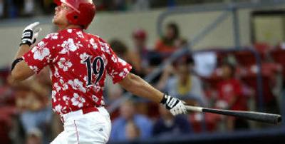 
Indians outfielder Chris Davis singles in the first inning before his two homers.  
 (Holly Pickett / The Spokesman-Review)