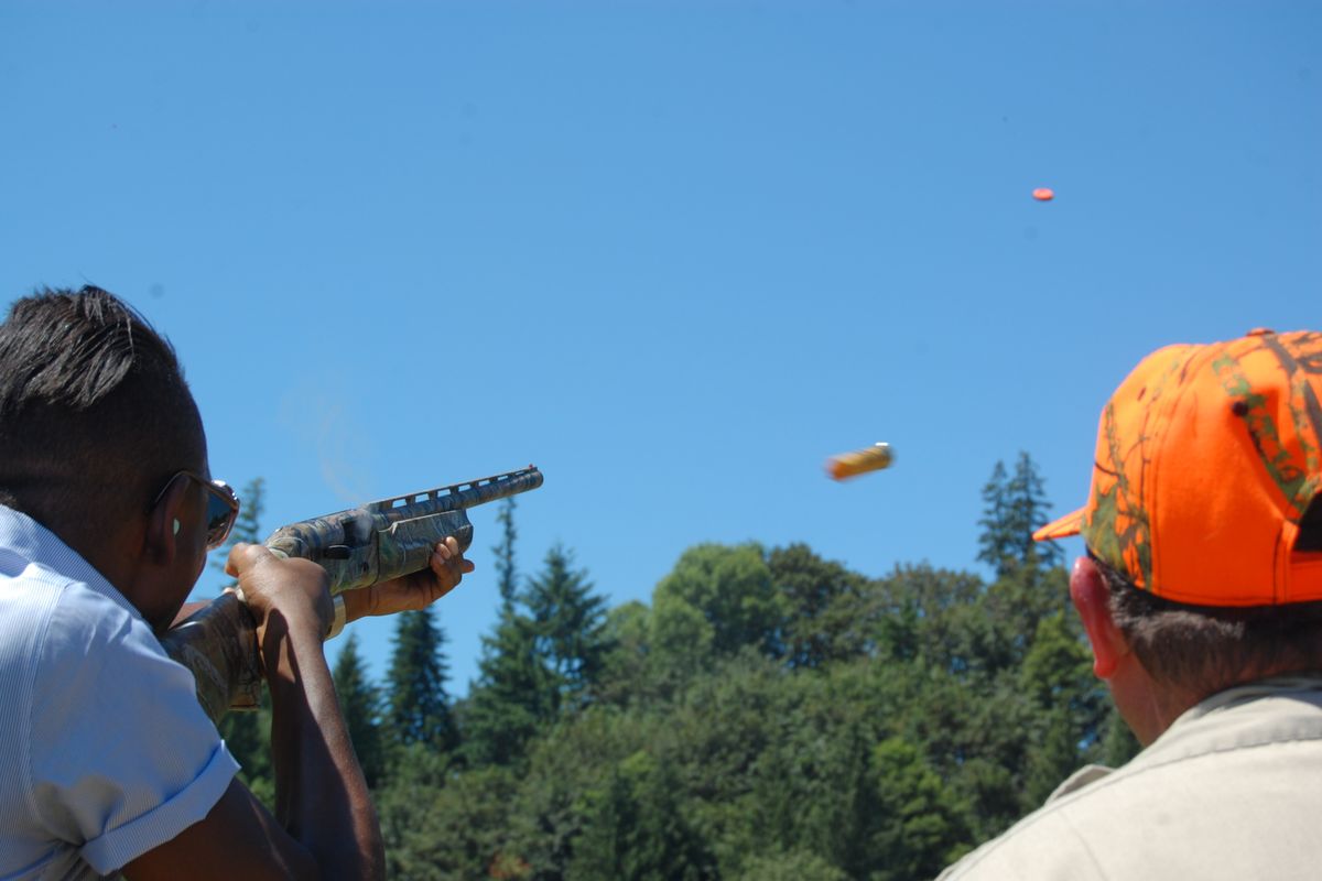 Chef Gregory Gourdet of the Portland restaurant Departure fires a .20-gauge shotgun during firearms training near Canby, Ore. (Associated Press)