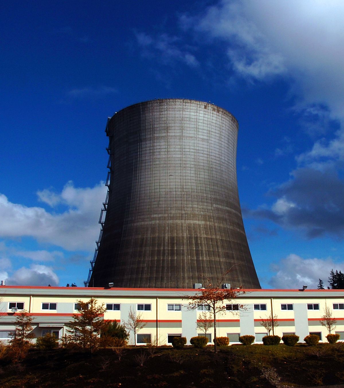 A 500-foot cooling tower dwarfs a business park near Elma, Wash. The tower is a relic of the failed WPPSS nuclear energy project.  (File Associated Press / The Spokesman-Review)