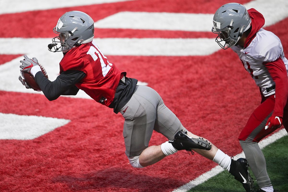 Washington State receiver Bode Brewer dives into the end zone with a touchdown catch against defensive back Dylan Clinton during a spring scrimmage Saturday at Gesa Field in Pullman.  (Tyler Tjomsland/The Spokesman-Review)
