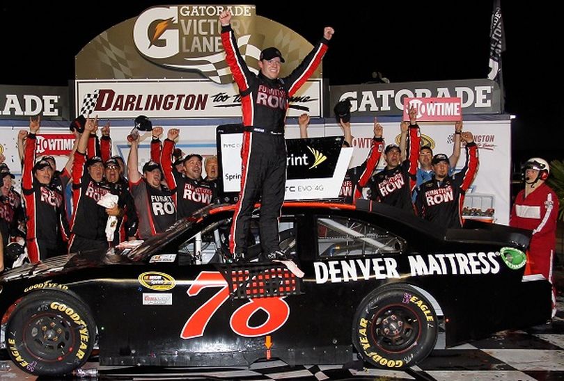 Regan Smith climbs out of the No.78 Furniture Row Chevrolet after winning the Showtime Southern 500 at Darlington Raceway . (Photo Credit: Geoff Burke/Getty Images for NASCAR) (Geoff Burke / Getty Images North America)