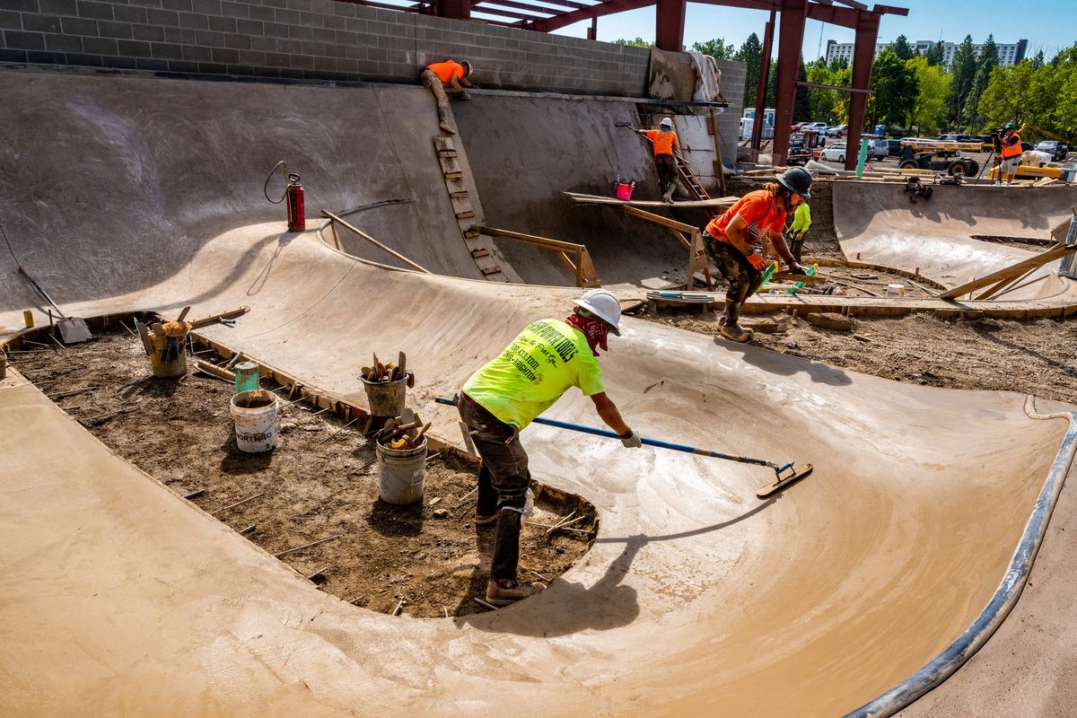 Workers build a new 8,500-square-foot wheels and skate park on the North Bank of Riverfront Park on Friday. It will feature two bowls, a hubba rail and ledges. The park is part of a $9.2 million regional playground that will be open to the public in spring. (Colin Mulvany/THE SPOKESMAN-REVIEW)
