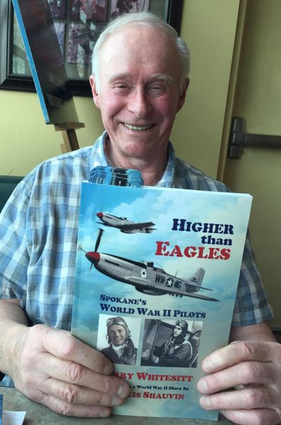 Larry Whitesitt holding his book about Spokane World War II pilots. (Doug Clark/The Spokesman-Review)