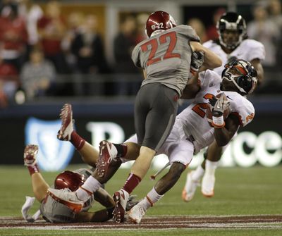 WSU’s Casey Locker (22) delivers a hard hit to OSU’s Markus Wheaton. Locker was flagged for unnecessary roughness on the play.  (Ted Warren / Associated Press)