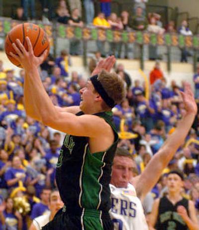 
EV's Trevor Slocum drives by Rogers' Andrew Durant in 