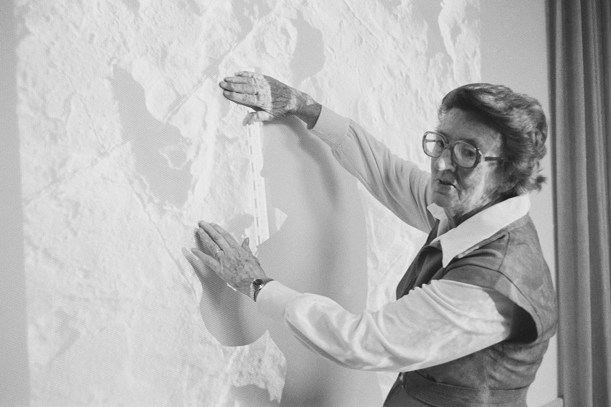 FILE - Dr. Mary D. Leakey, of the National Geographic Society in Washington, Feb. 24, 1978 holds hands near a picture of a footprint found at Laetolil, Tanzania. It is believed the track belongs to a hominid who lived between 34 and 3-¾ million years ago and was about 4-foot tall. rehistoric footprints that have puzzled scientists since the 1970s are getting a second look: Were they left by extinct animals or by human ancestors? When famed paleontologist Mary Leakey first uncovered the footprints in Tanzania 40 years ago, the evidence was ambiguous.  (STF)