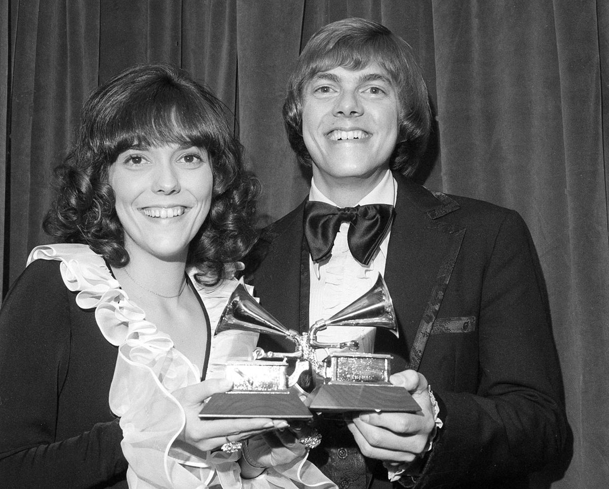 In this March 14, 1972, file photo, siblings Karen and Richard Carpenter of the vocal duo Carpenters pose with their Grammys for best pop vocal performance by a group during the 14th annual 1971 Grammy Awards in New York. More than 30 years after the release of the last Carpenters vinyl record, newly remastered versions of 12 of their hit albums are due to be released on LPs on Friday, Nov. 17, 2017. (Associated Press)