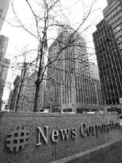 
The headquarters of NBC Universal towers over a sign for News Corp.'s headquarters in New York.  The companies have joined with  several major Internet companies to distribute TV shows, video clips and movies online. 
 (The Spokesman-Review)