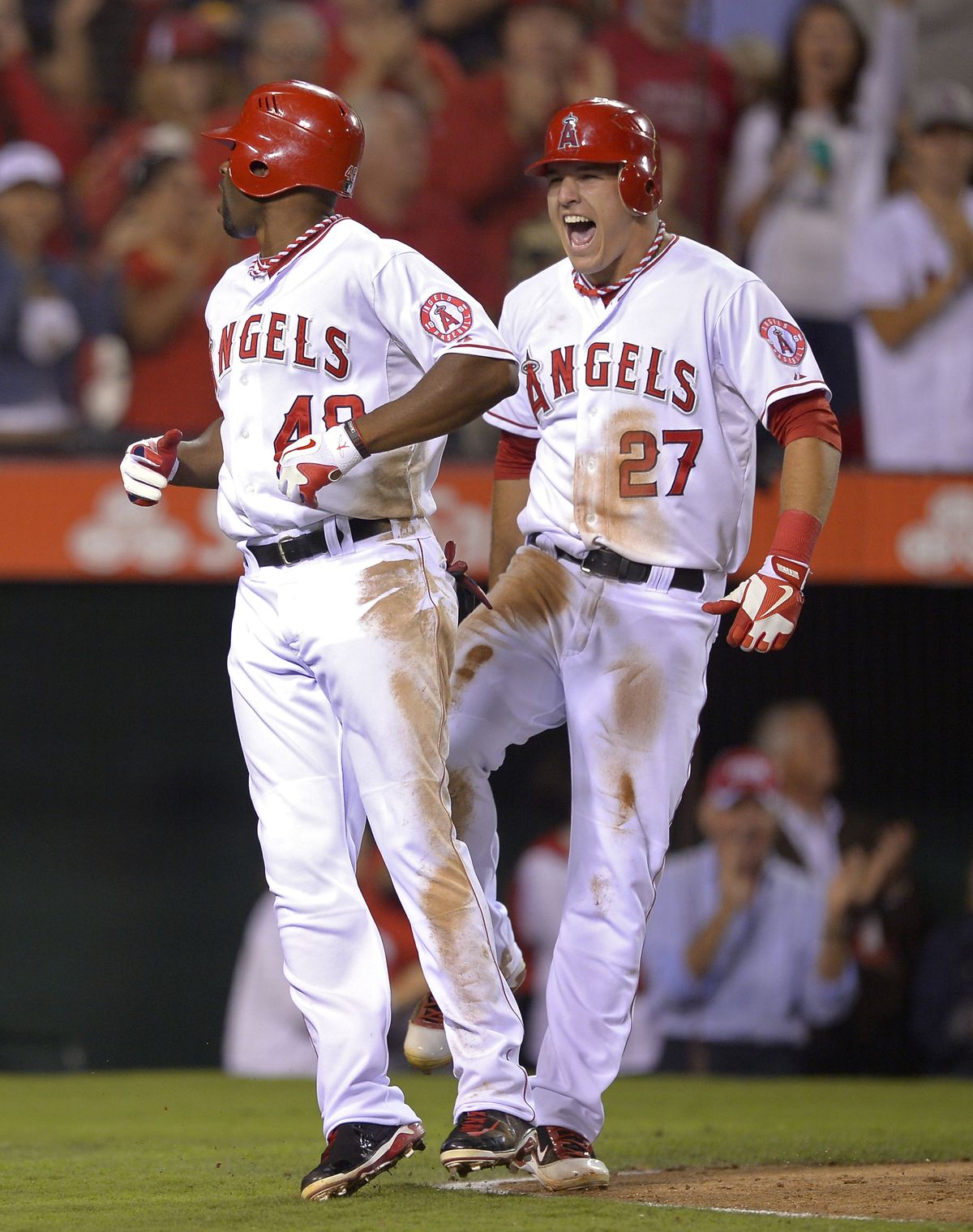 Angels’ Torii Hunter, left, celebrates his two-run home run with teammate Mike Trout on Tuesday. (Associated Press)