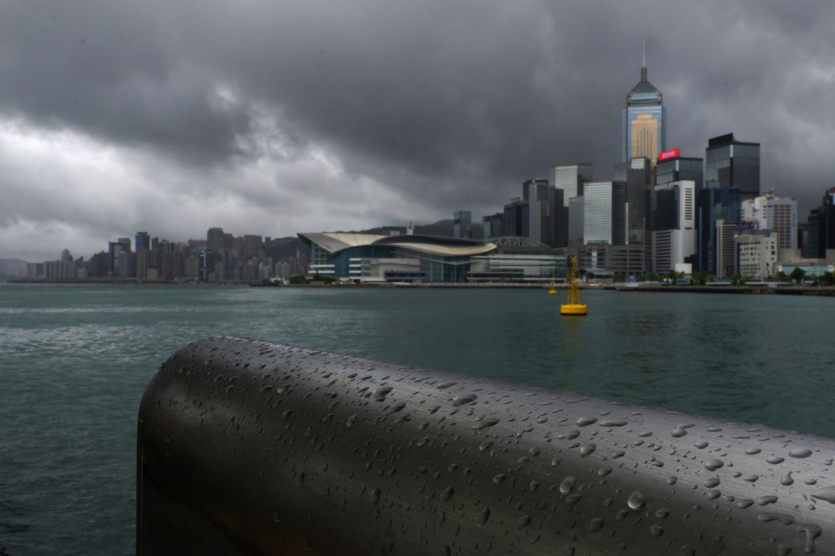 Rain droplets line a railing along the waterfront of Victoria Harbour in Hong Kong Wednesday, Aug. 19, 2020. Typhoon Higos weakened to a strong topical storm after making landfall in Zhuhai city on Wednesday morning on China