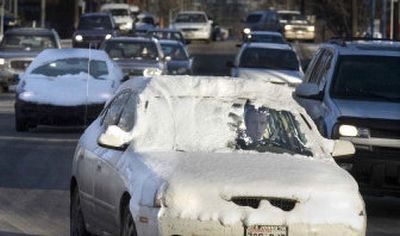 Cars heading into Spokane Thursday from the north on Ash Street show the effects of a snowstorm.
(Christopher Anderson / The Spokesman-Review)