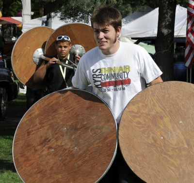 Ben Allen, 20, right,  and Josh Patrick, 18, of A to Z Rental, heft tables in Riverfront Park as they make their way to a Pig Out in the Park beer garden on Tuesday. Pig Out begins today and continues through Monday. (Dan Pelle / The Spokesman-Review)