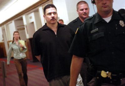 
Richard Atkinson is led into a courtroom at the Spokane County Courthouse on Monday where he is on trial for the death of his wife, Andrea Atkinson. 
 (Holly Pickett / The Spokesman-Review)