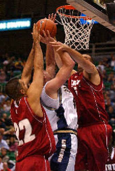 
Brigham Young's Garner Meads, center, is fouled by Washington State's Shami Gill.
 (Associated Press / The Spokesman-Review)