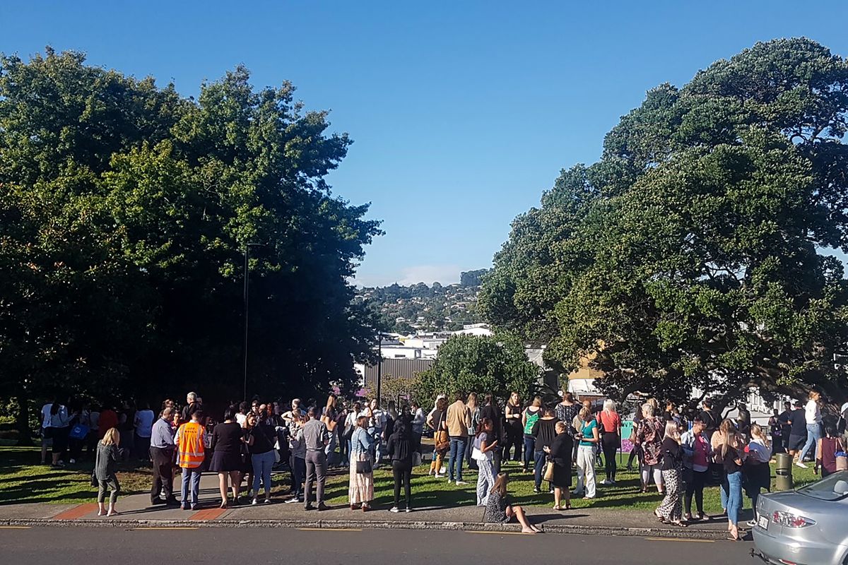 People gather on high ground in Whangarei, New Zealand, as a tsunami warning is issued Friday, March 5, 2021. A powerful magnitude 8.1 earthquake struck in the ocean off the coast of New Zealand prompting thousands of people to evacuate and triggering tsunami warnings across the South Pacific.  (Mike Dinsdale)