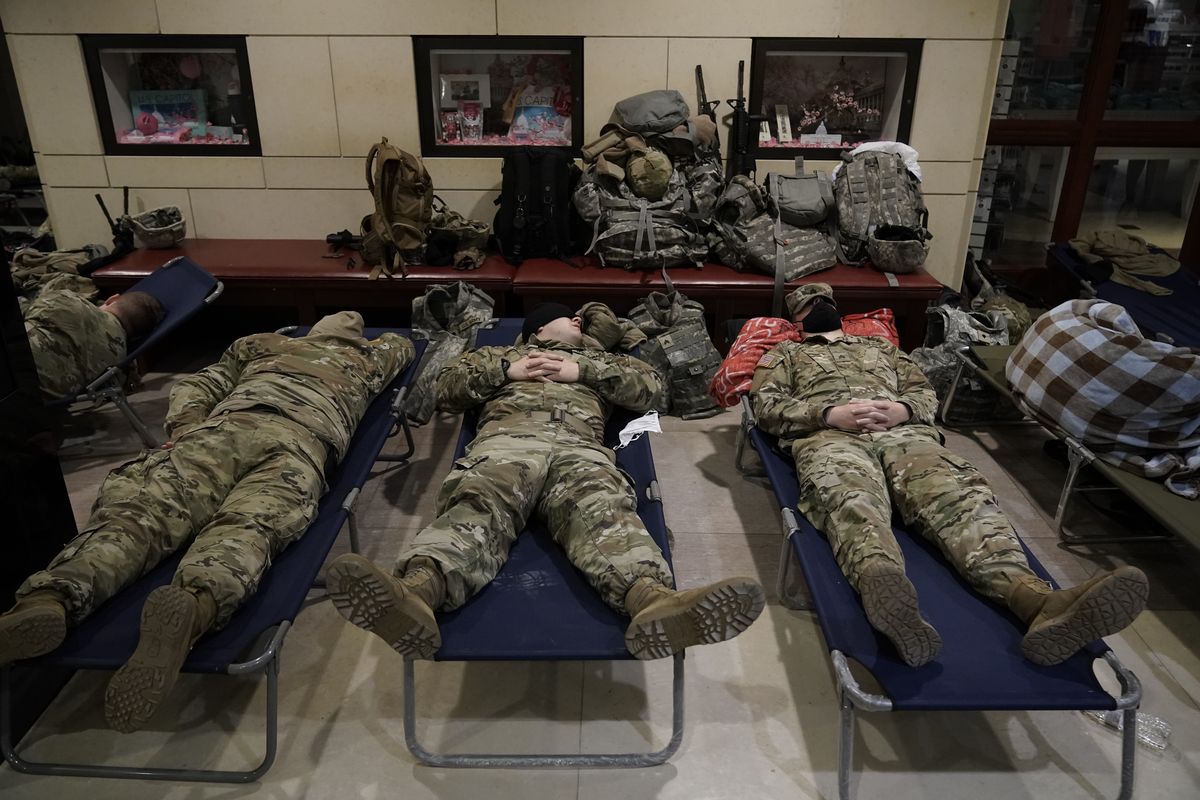 In this Jan. 18, 2021 photo, National Guard troops sleep inside the Capitol Visitor